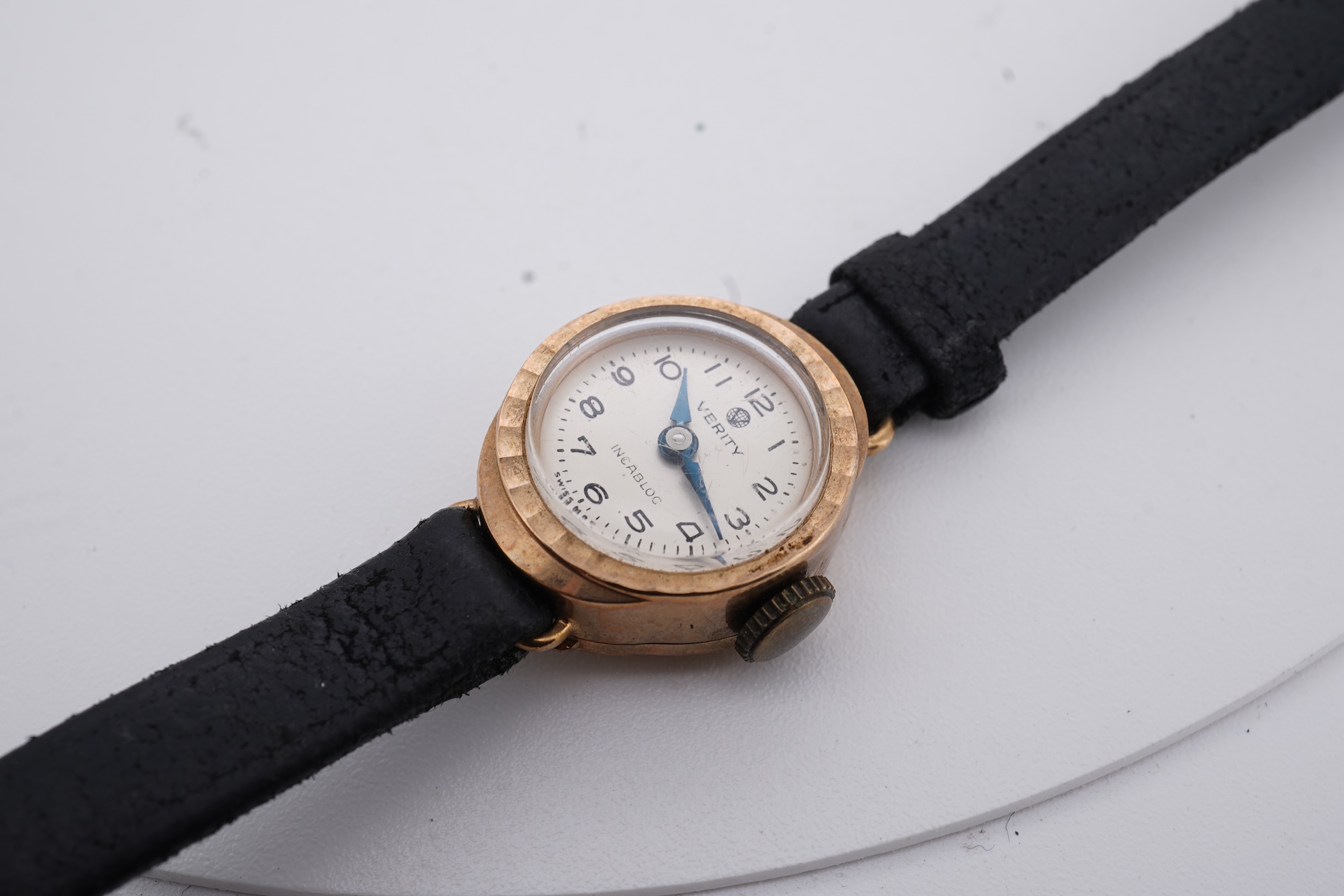 A lady's 9ct gold Verity manual wind wrist watch, with Arabic dial, case diameter 22mm, on a leather strap, together with one other lady's 9ct gold manual wind wrist watch, on a fabric strap.